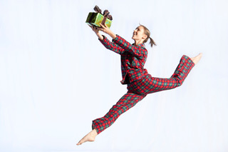 Dancer leaping with Christmas present
